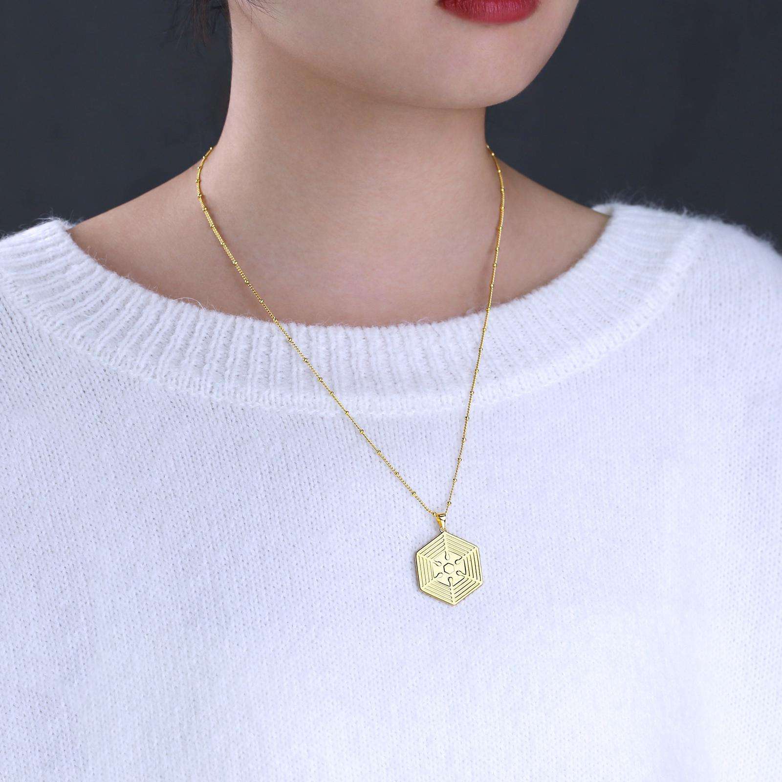 Necklace with "My Time is Now, My Moment is Now" engraving. Spanish version on the back.