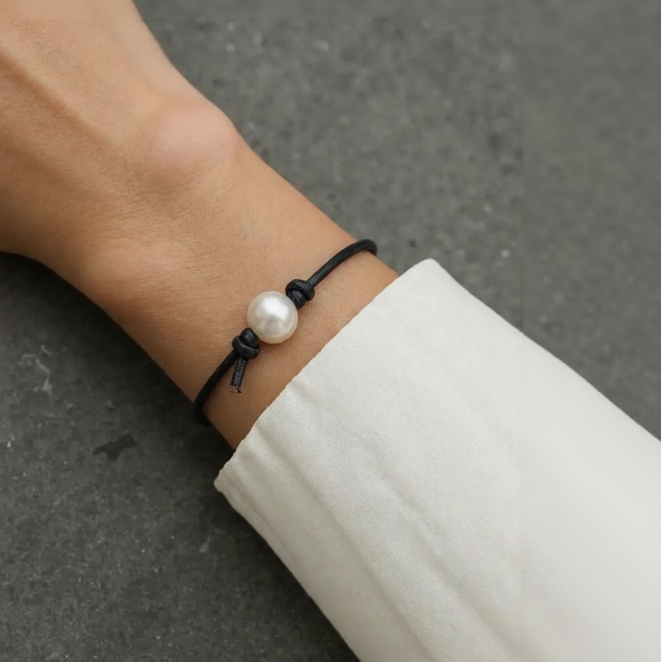 Pearl bracelet on a wrist with a blurred background