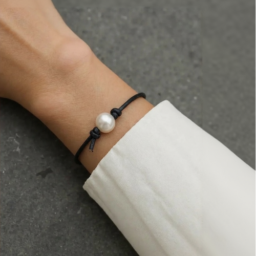Pearl bracelet on a wrist with a blurred background