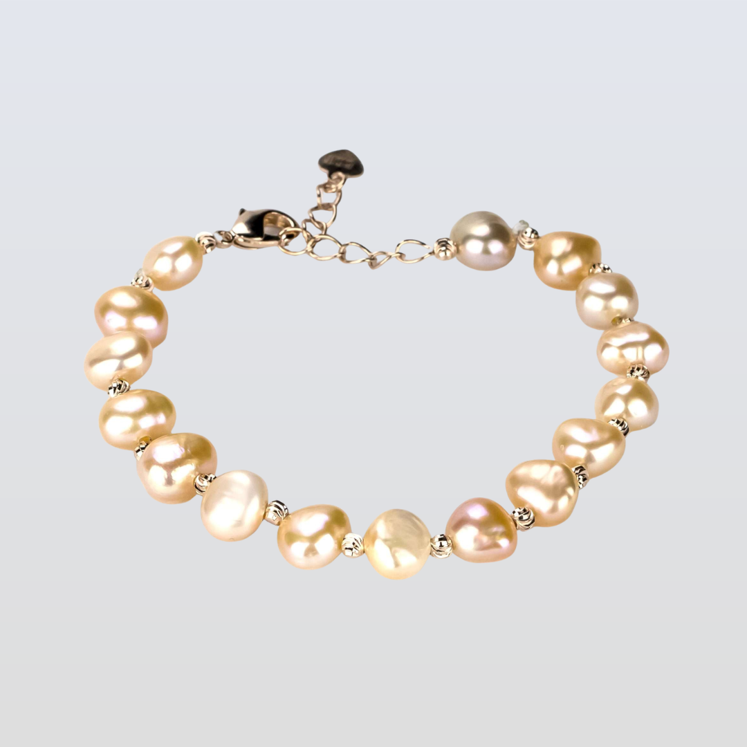Pearl bracelet with gold accents on a light gray background