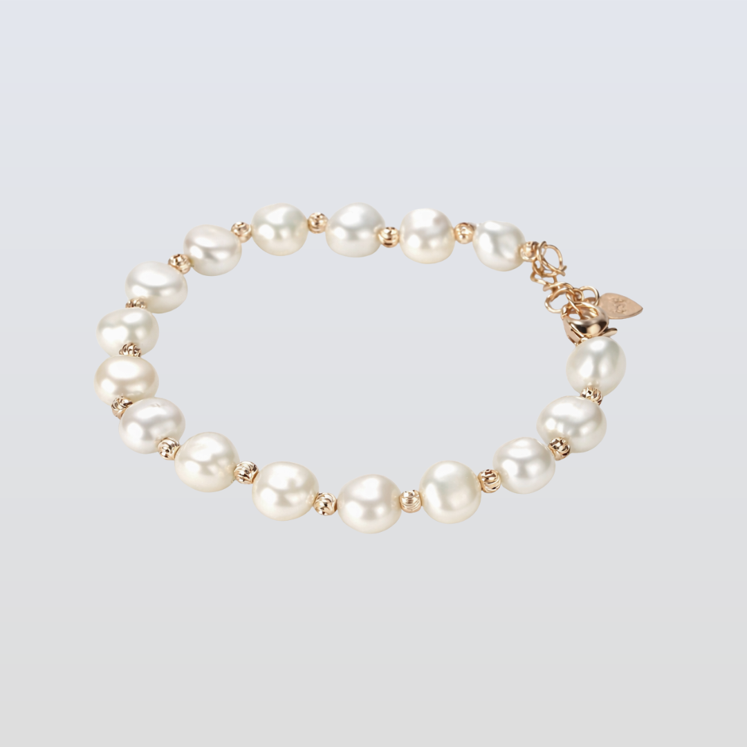Pearl bracelet with gold accents on a light gray background