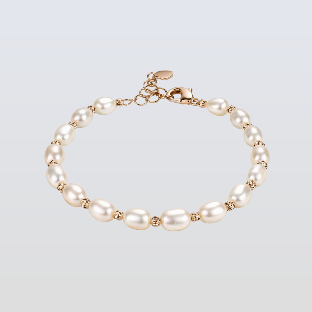 Pearl bracelet with gold accents on a light gray background