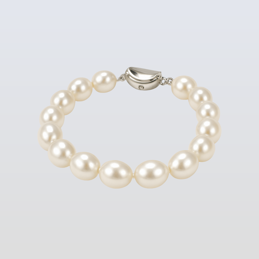 Pearl bracelet with silver clasp on a light gray background