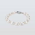Pearl bracelet with a silver clasp on a light gray background