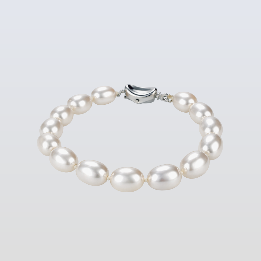 Pearl bracelet with a silver clasp on a light gray background