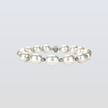 Pearl bracelet with silver accents on a light gray background