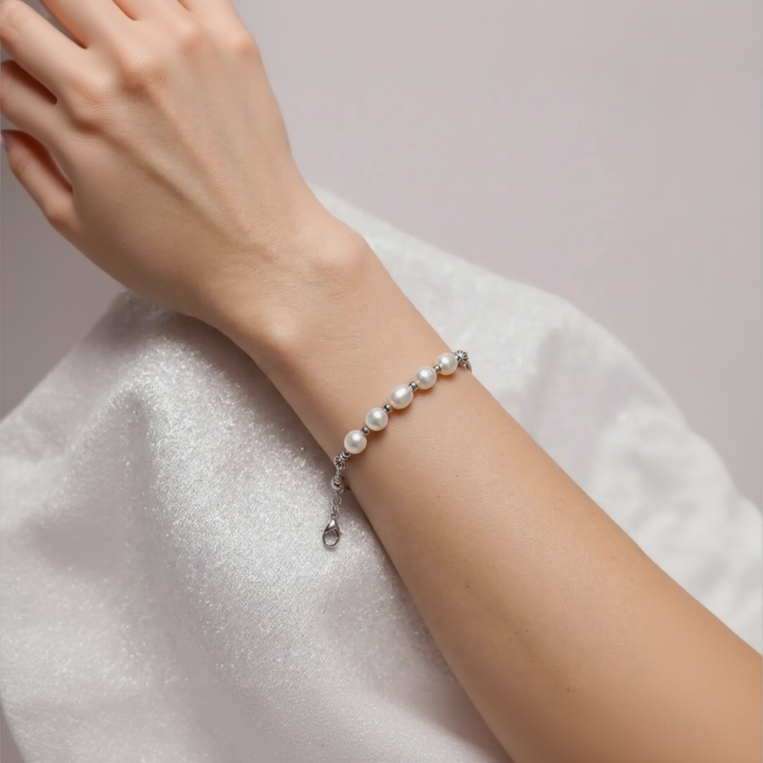 Pearl bracelet on a person's wrist with a soft background