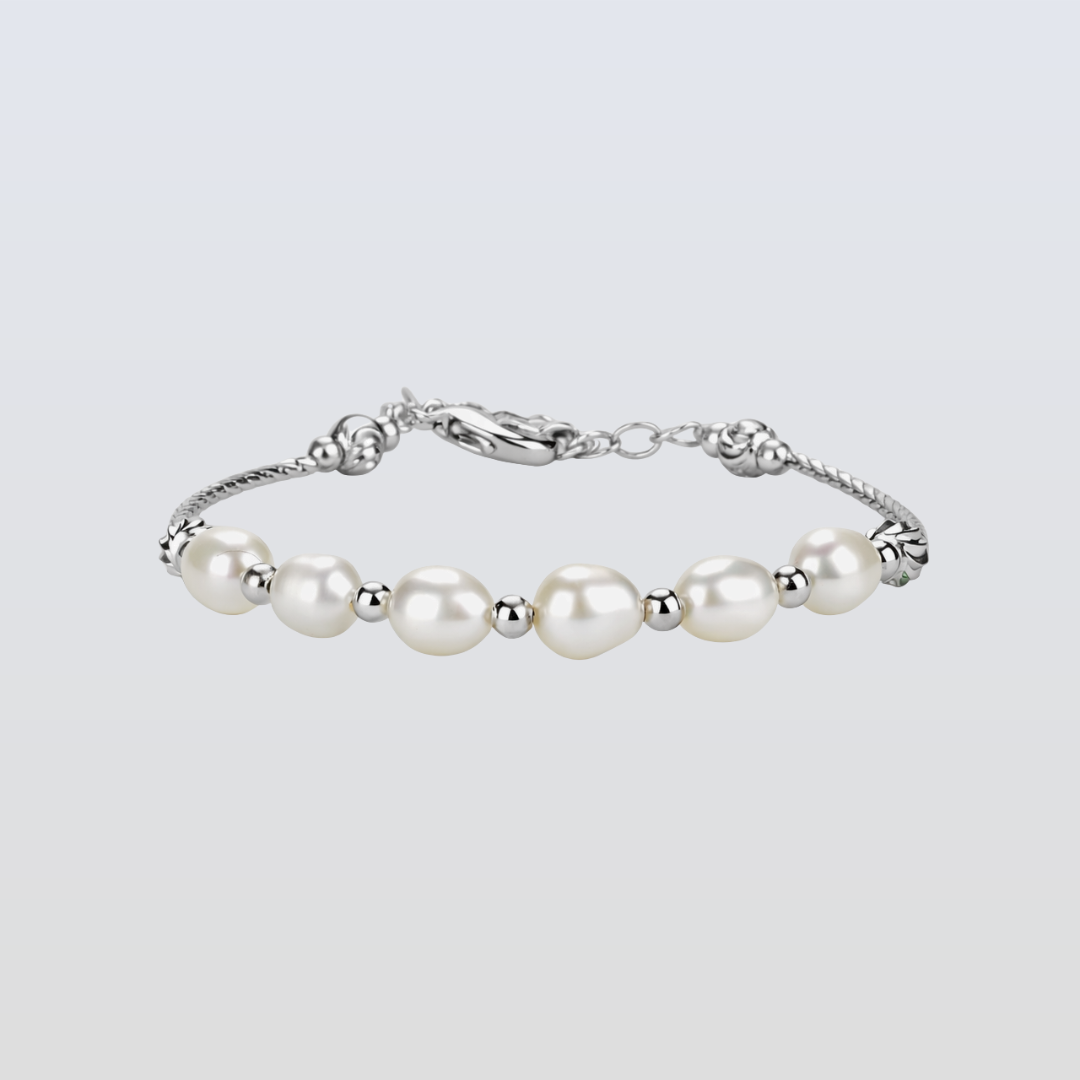 Pearl bracelet with silver clasp on a light gray background