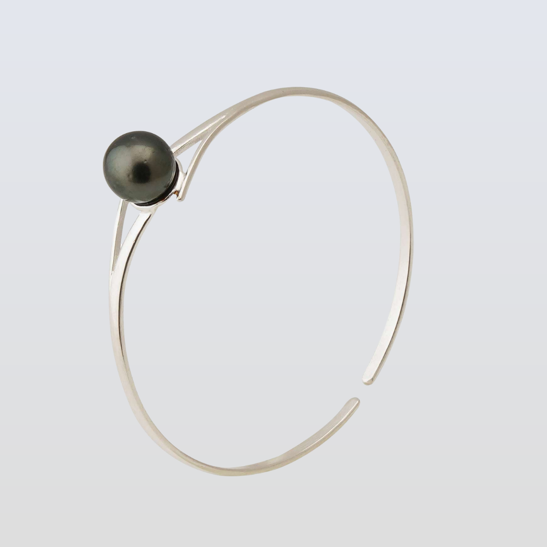 Silver bracelet with a black pearl on a light gray background