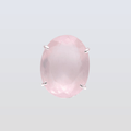 Pink gemstone with silver prongs on a light gray background