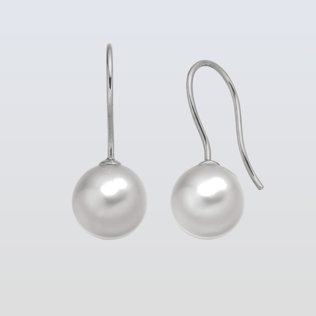 Pair of pearl earrings on a light gray background