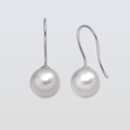 Pair of pearl earrings on a light gray background