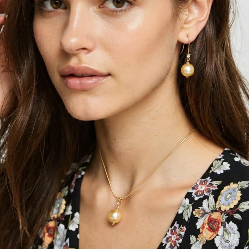 Woman wearing gold earrings and necklace with a neutral background
