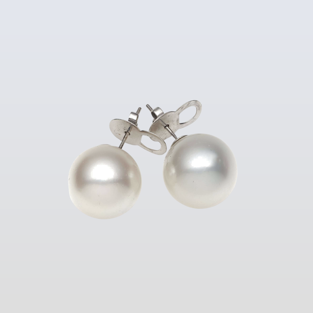 Pearl earrings on a light gray background