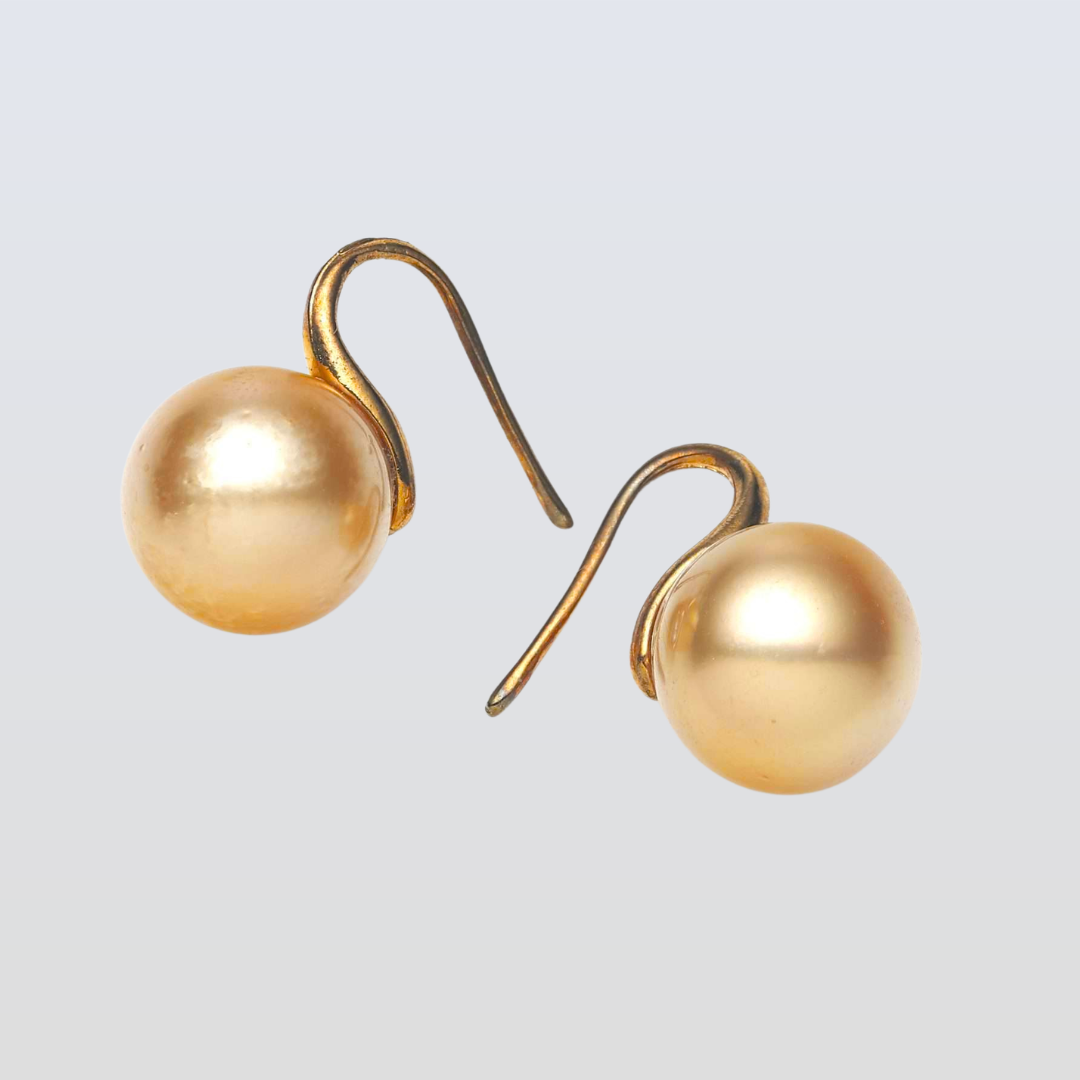 Pair of pearl earrings on a light gray background
