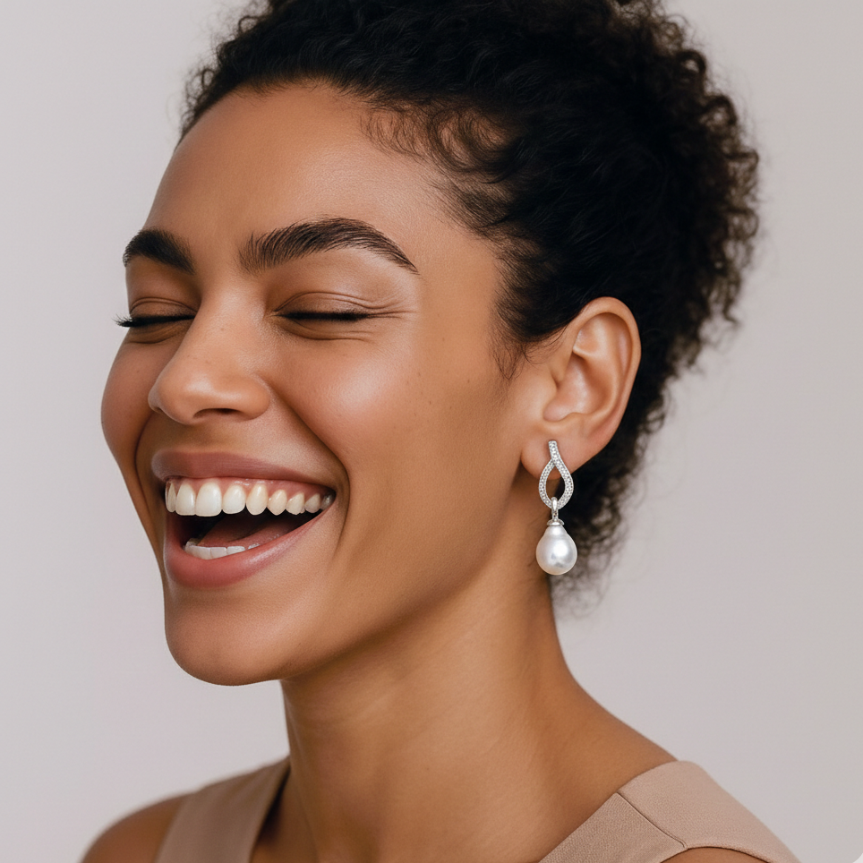 Woman wearing a pearl earring with a plain background