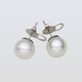 Pearl earrings on a light gray background
