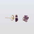 Amethyst stud earrings on a light gray background