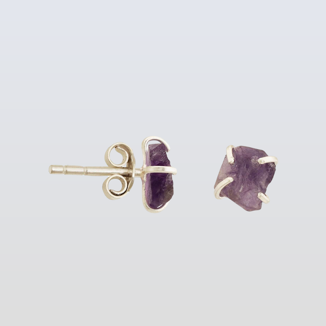 Amethyst stud earrings on a light gray background