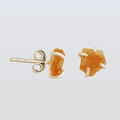 Gold stud earrings with orange gemstones on a light gray background