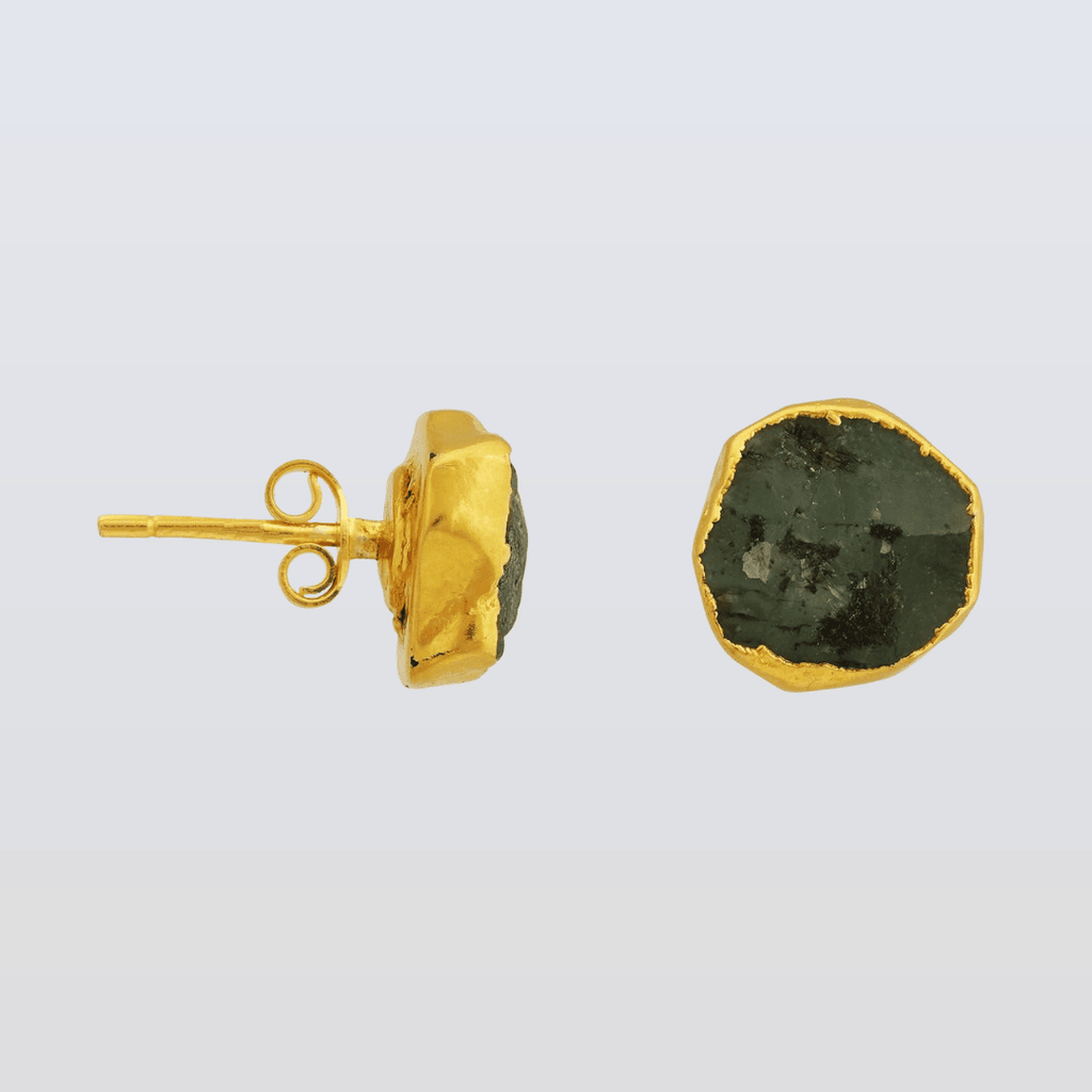 Gold earrings with green stone on a light gray background