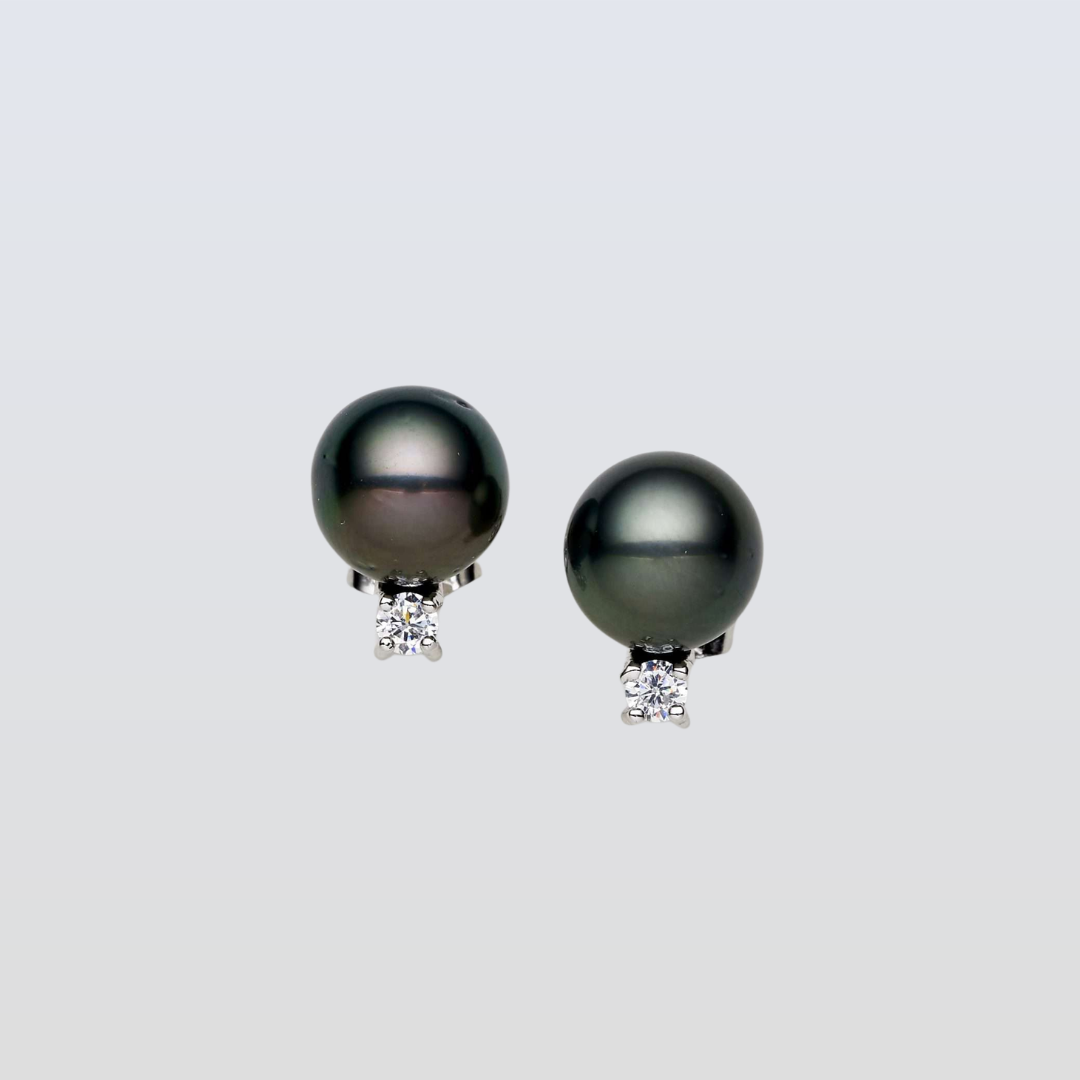 Pair of black pearl earrings with diamond accents on a light gray background