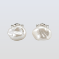 Pair of pearl earrings on a light gray background