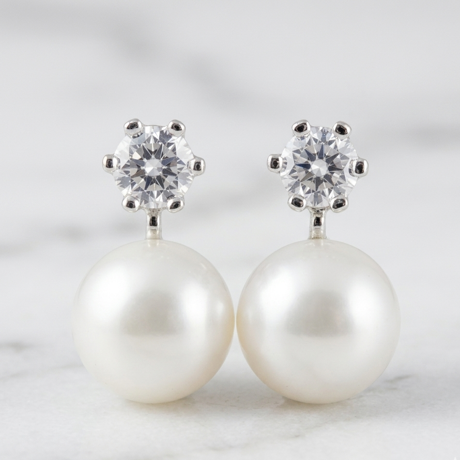 Pearl earrings with crystal tops on a light background