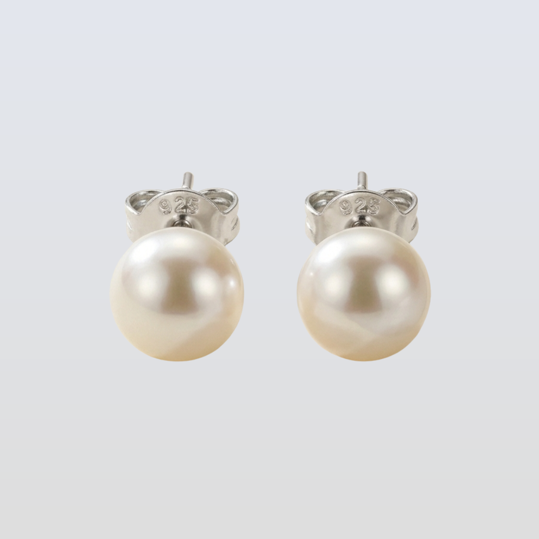 Pair of pearl earrings on a light gray background