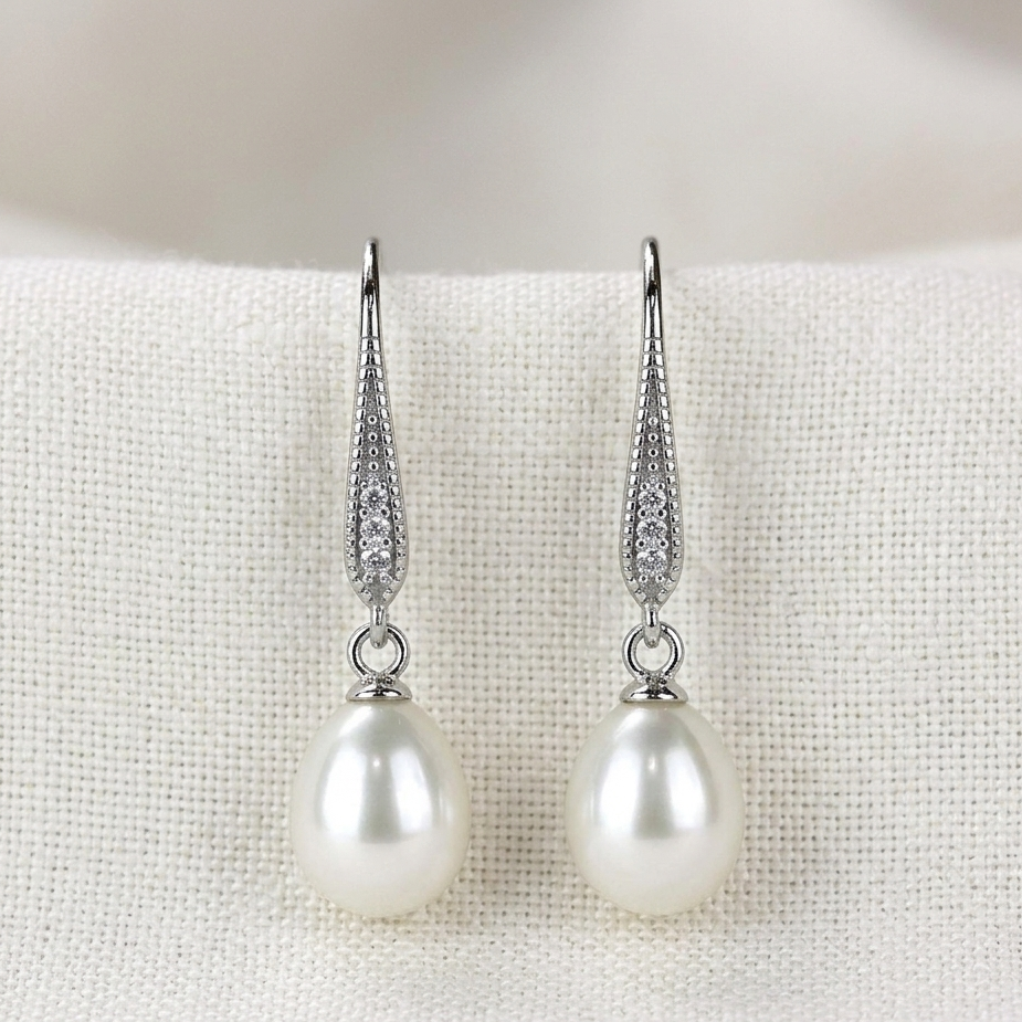 Pearl earrings with silver hooks on a white background