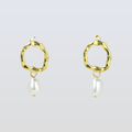 Gold hoop earrings with pearl drops on a light gray background
