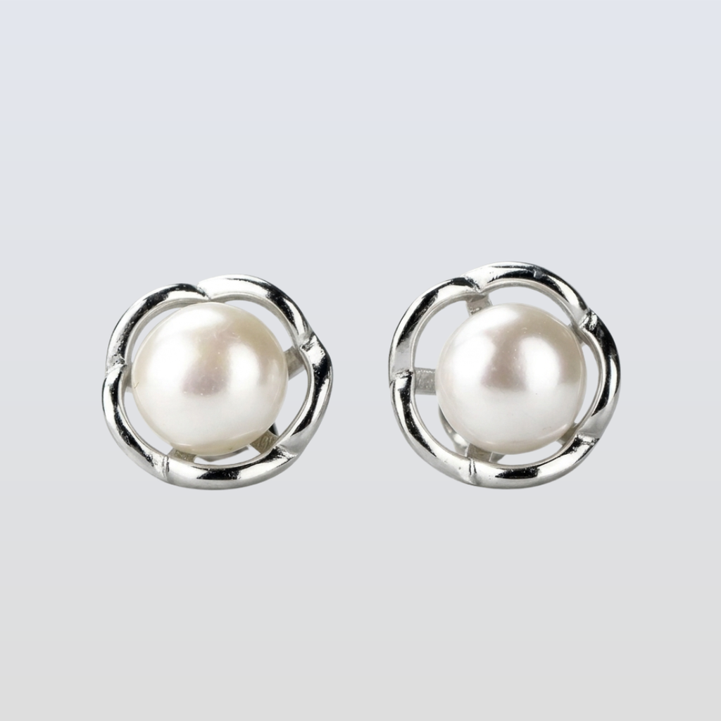 Pearl earrings with silver circular frames on a light gray background