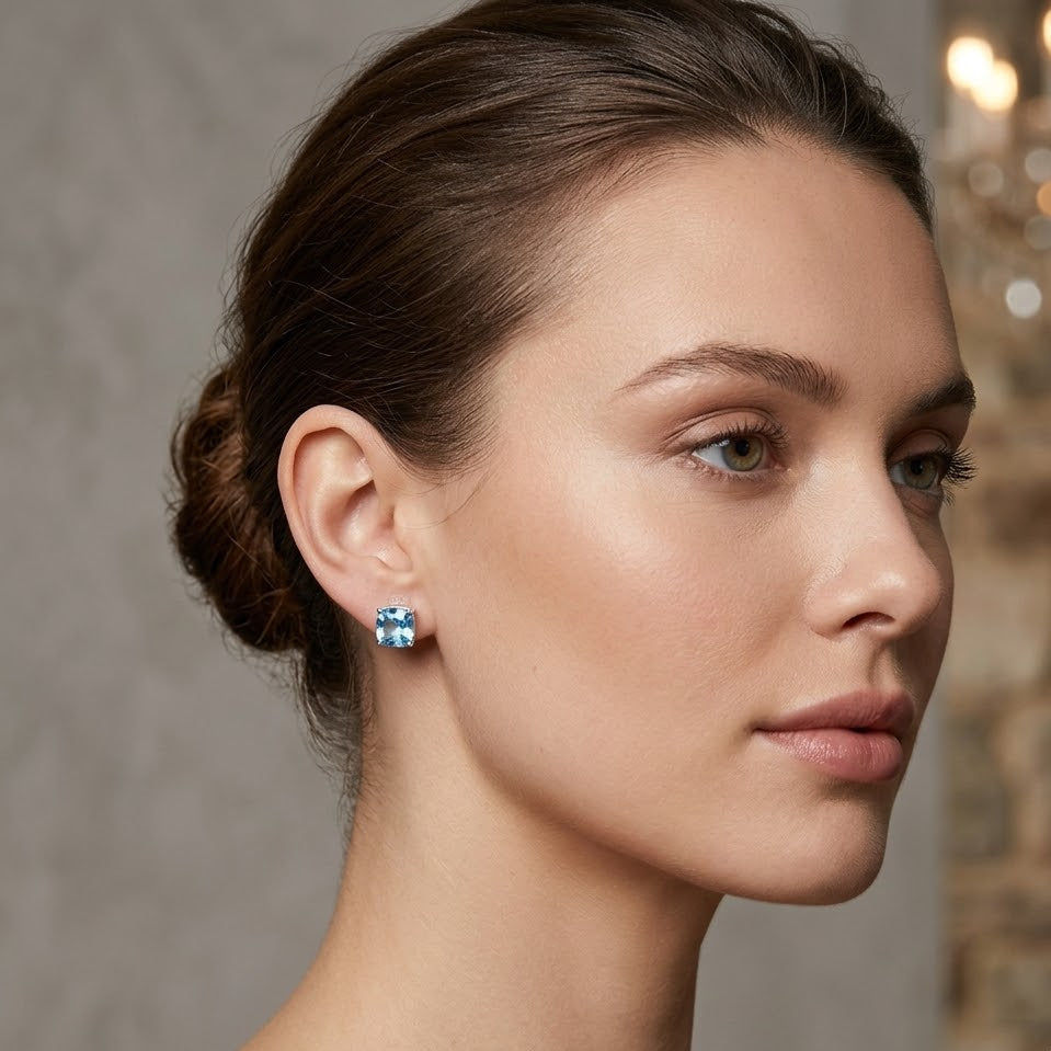 Close-up of a woman wearing blue earrings with a blurred background