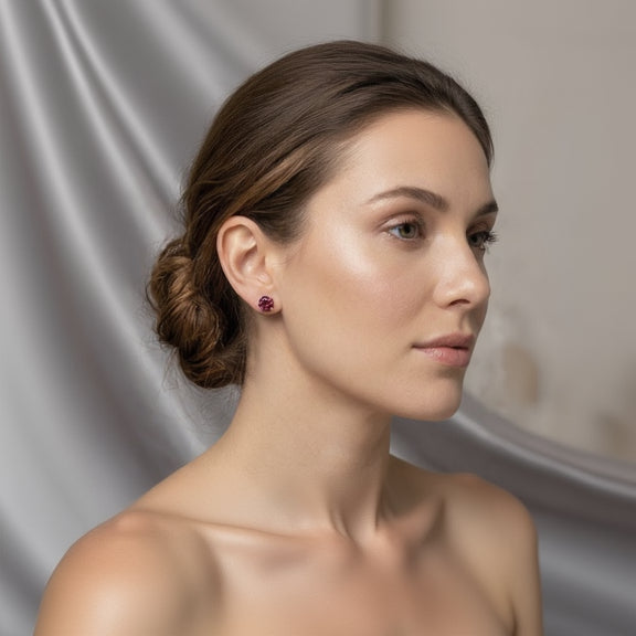Woman wearing a pair of earrings with a neutral background