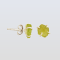 Pair of green stone stud earrings on a light gray background