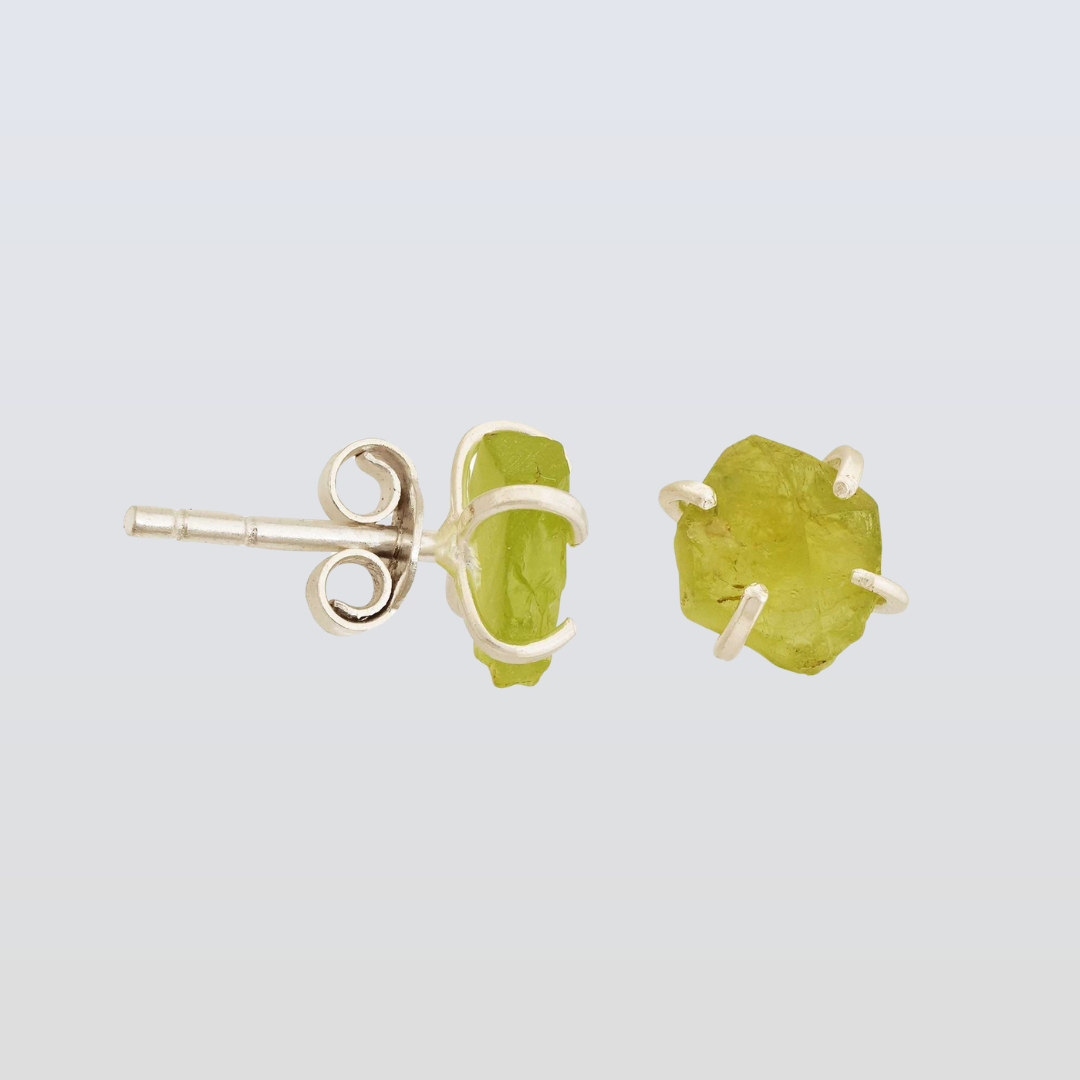 Pair of green stone stud earrings on a light gray background