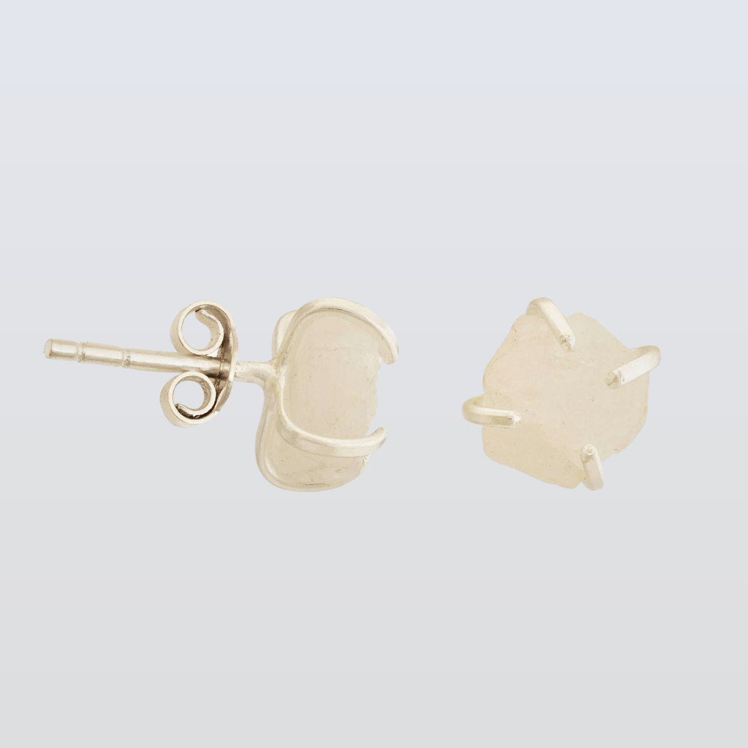 light pink stone stud earrings on a light gray background