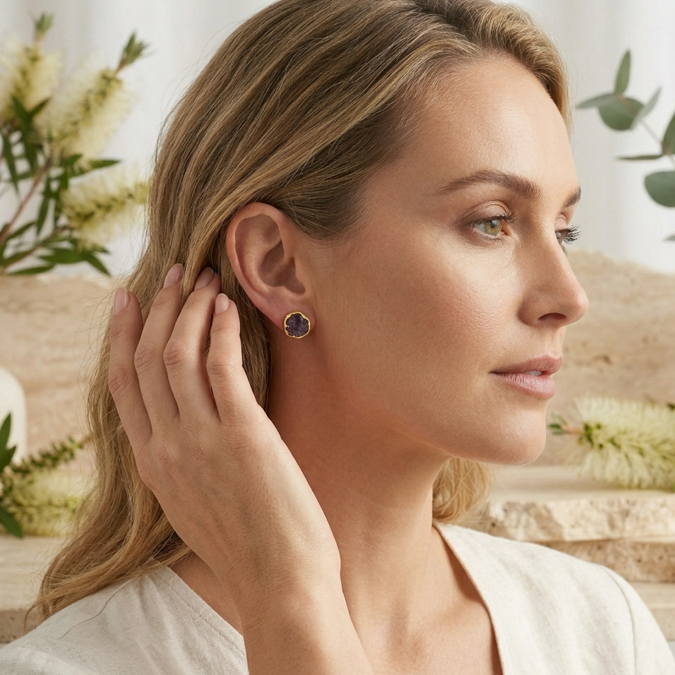 Woman wearing earrings with a blurred natural background