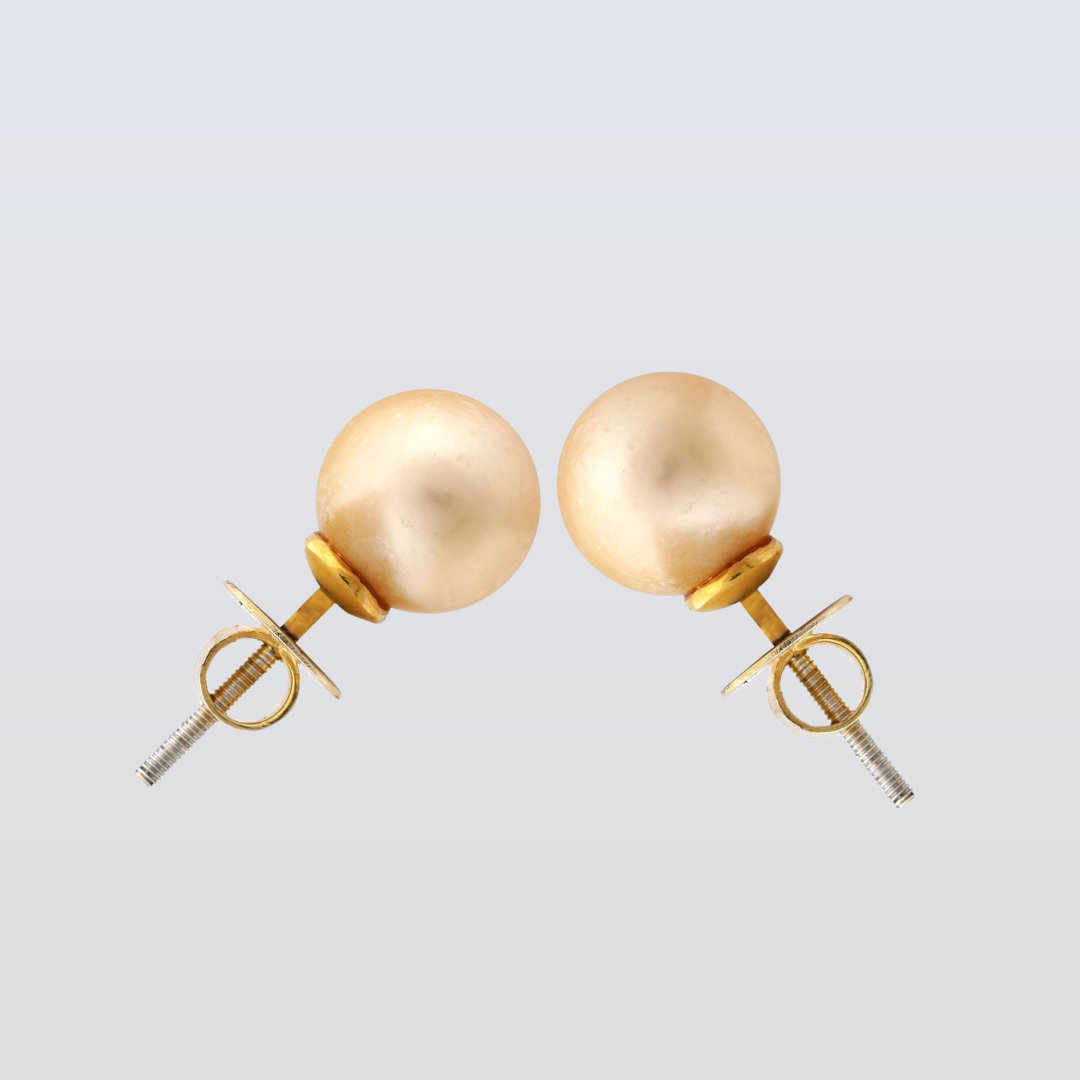 Pair of gold stud earrings on a light gray background