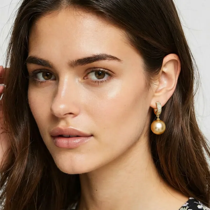 Close-up of a woman wearing pearl earrings with a neutral background