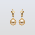 Pair of gold earrings with pearls and small diamonds on a light gray background