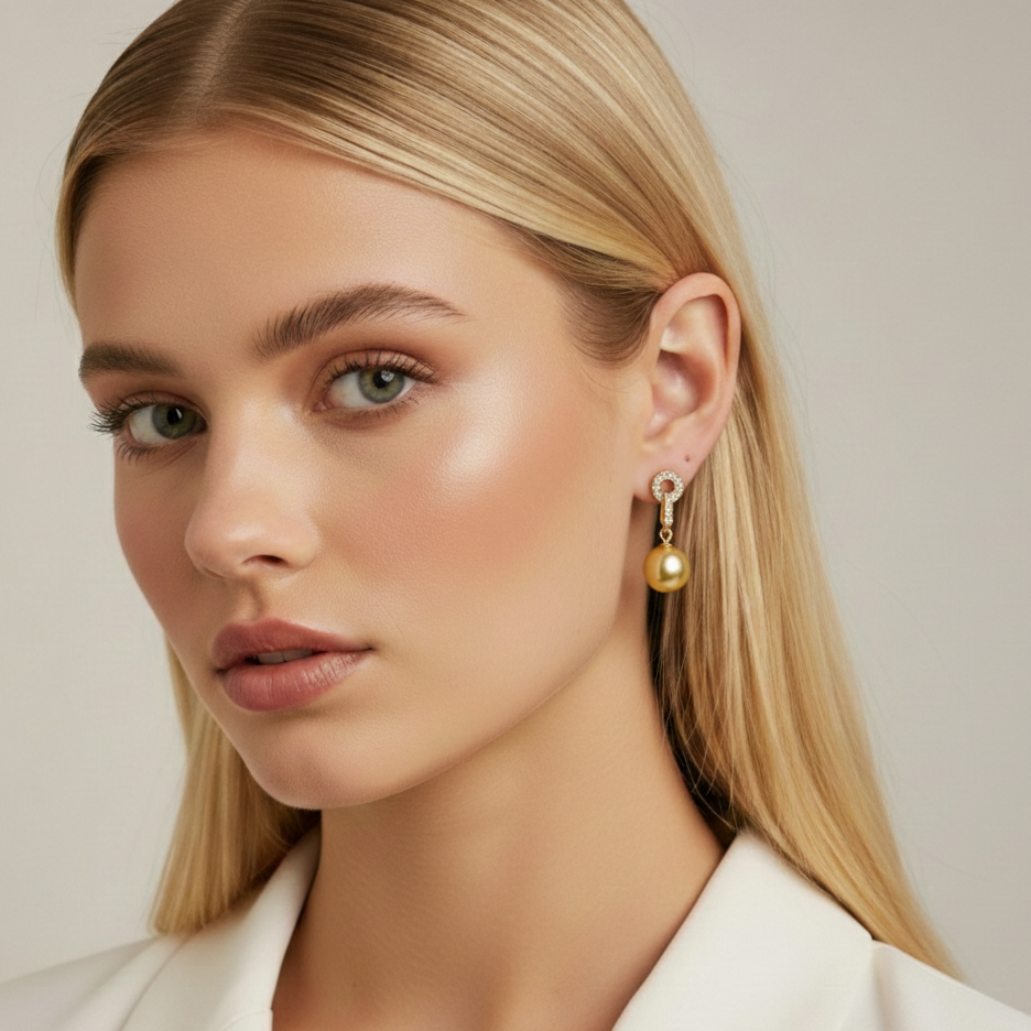 Close-up of a woman wearing gold earrings with a neutral background