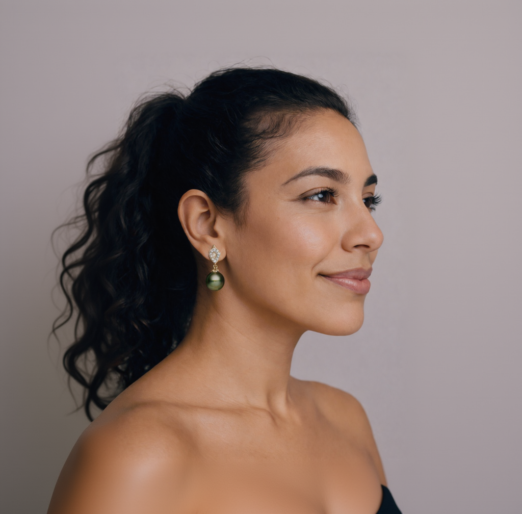 Woman wearing green earrings with a neutral background