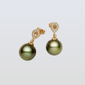 Gold earrings with green pearls on a light gray background