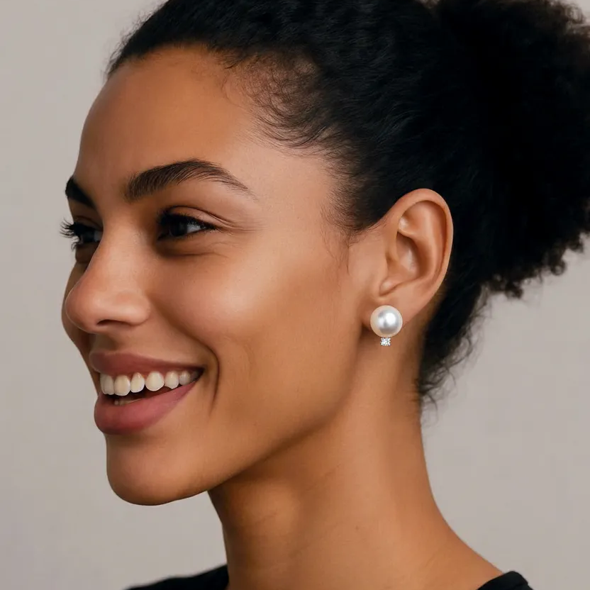 Woman wearing pearl earrings with a neutral background