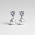 Pair of pearl and crystal earrings on a light gray background
