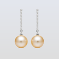 Pair of pearl earrings with diamond accents on a light gray background