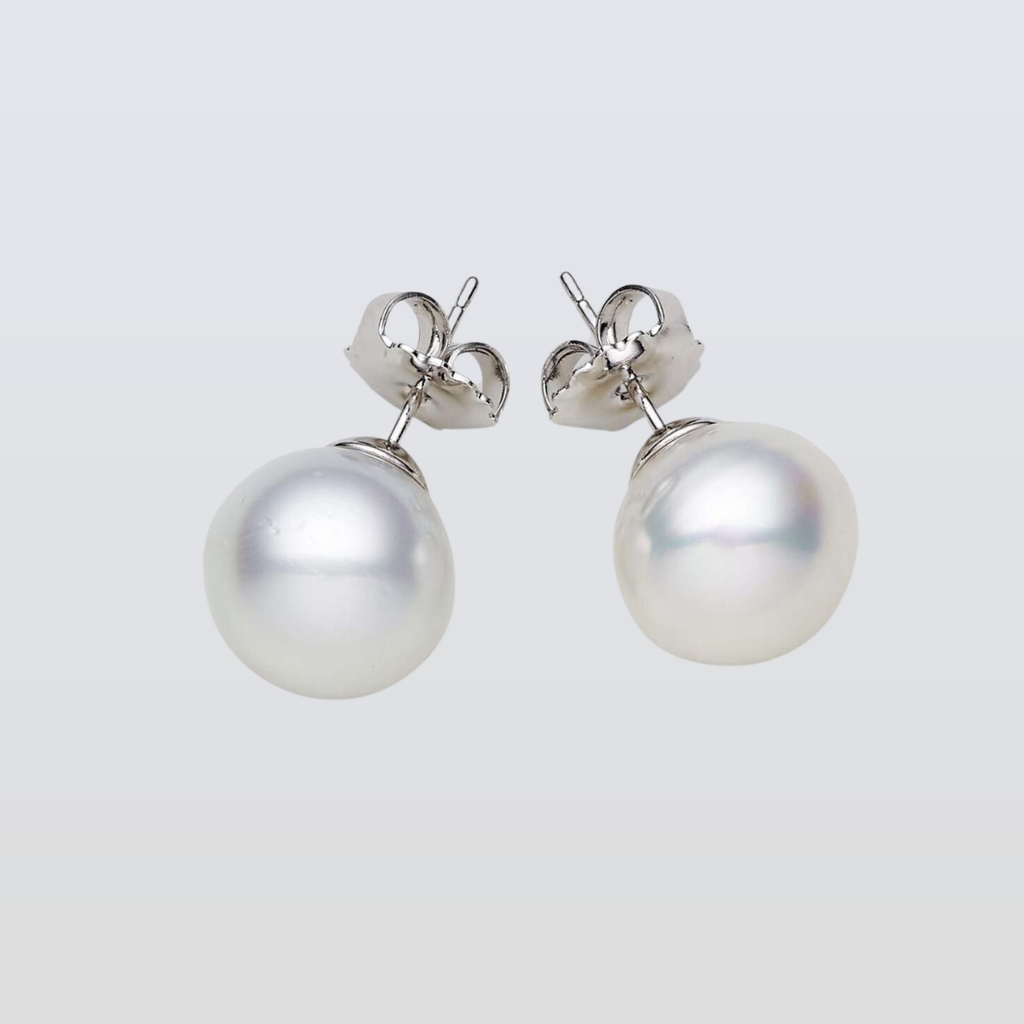 Pearl earrings on a light gray background