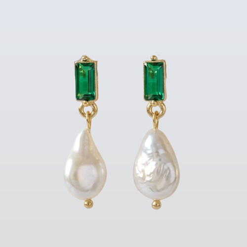 Pair of earrings with green gemstones and pearl drops on a white background