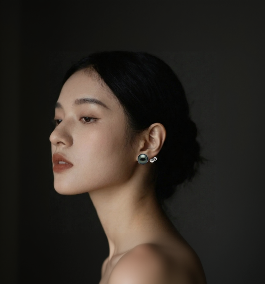 Side profile of a person wearing earrings against a dark background